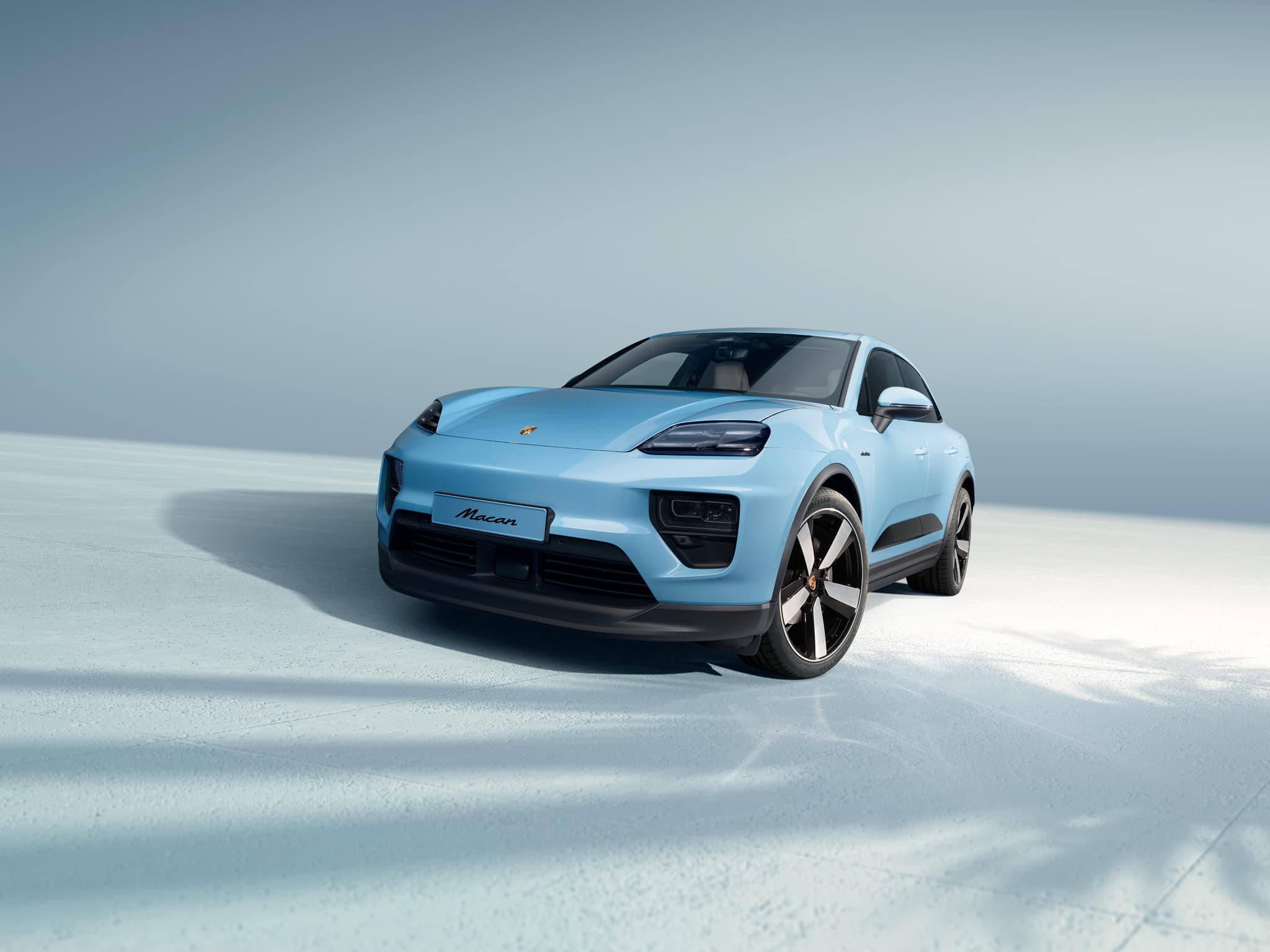 A Porsche Macan driving on an open road.